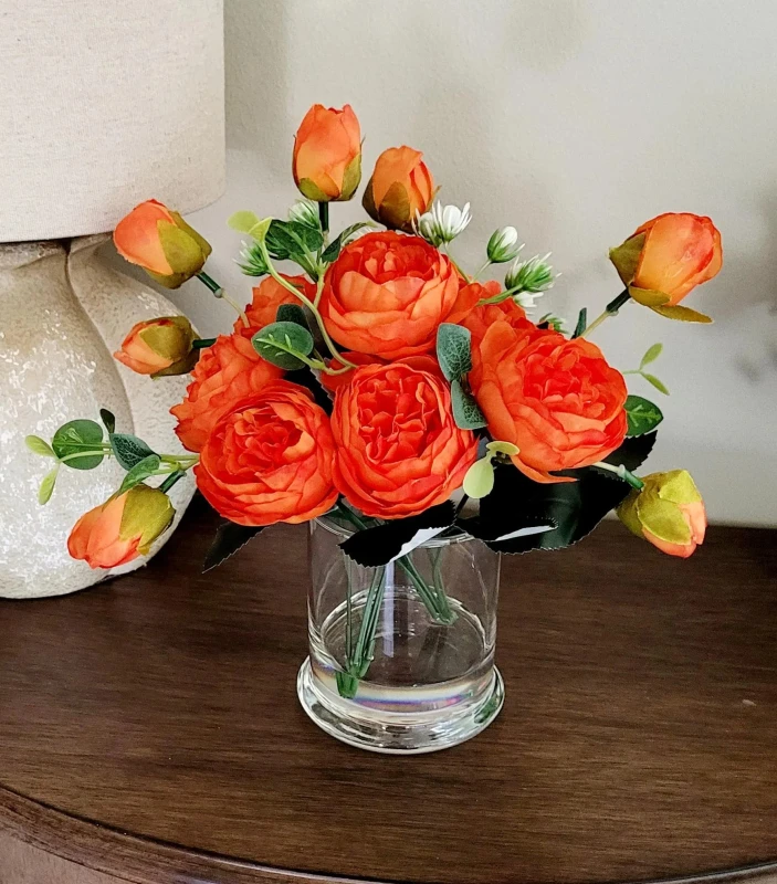 A Touch of Tangerine Elegance  Blooming Brightness  Orange Blossoms in a Textured White Vase  Radiant Floral Charm