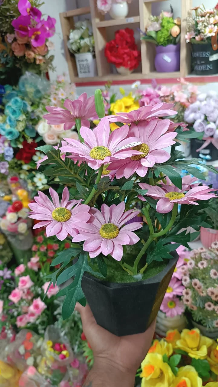 Artificial Flower Top Highlights the soft, charming pink hue of the petals.