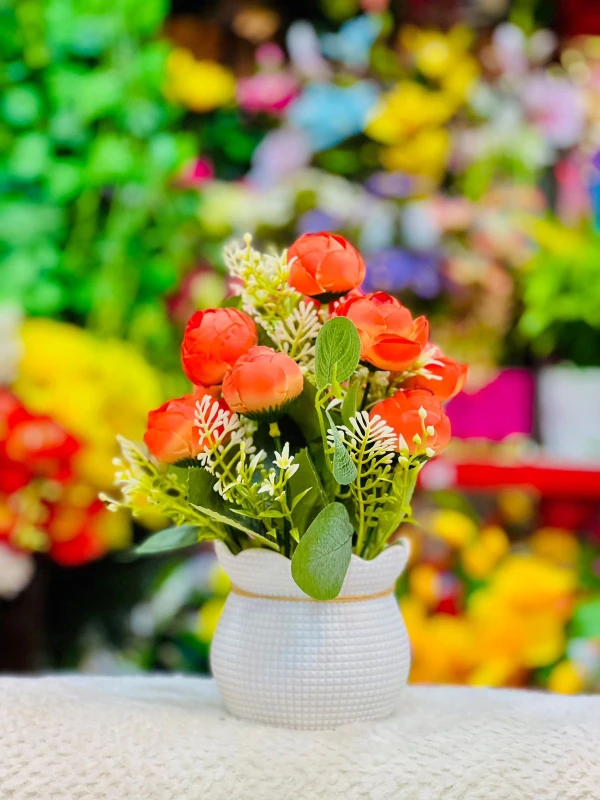 A Touch of Tangerine Elegance  Blooming Brightness  Orange Blossoms in a Textured White Vase  Radiant Floral Charm